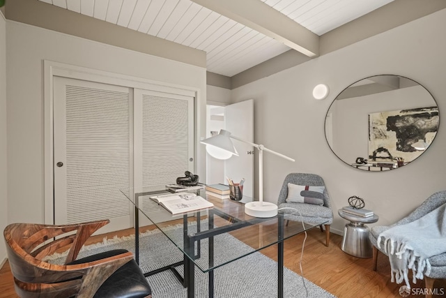 home office with wooden ceiling, beamed ceiling, and wood finished floors