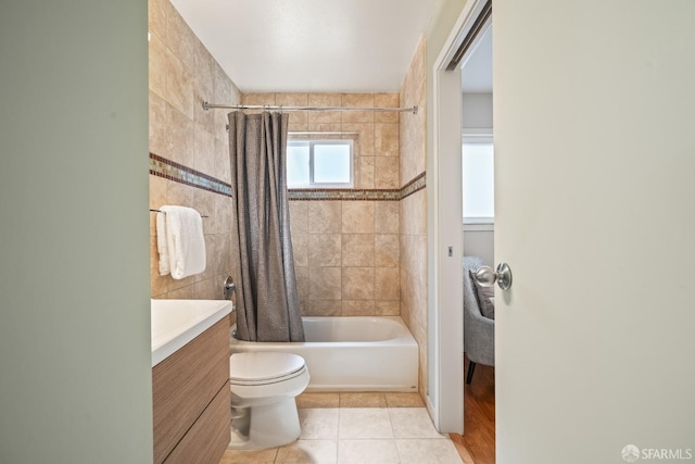 bathroom featuring tile patterned flooring, shower / tub combo, toilet, and vanity