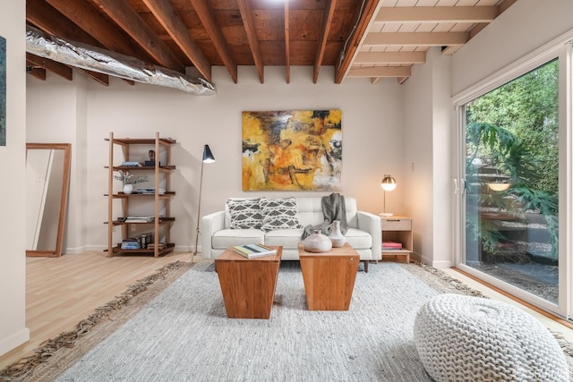 living area with beamed ceiling, baseboards, wood ceiling, and wood finished floors