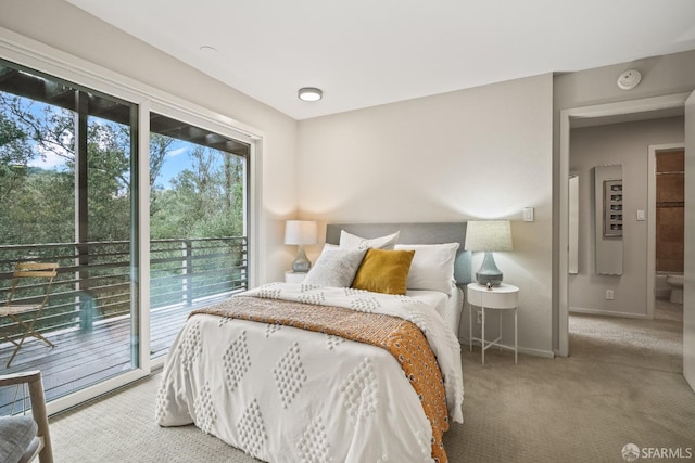 bedroom featuring baseboards, access to exterior, and carpet flooring