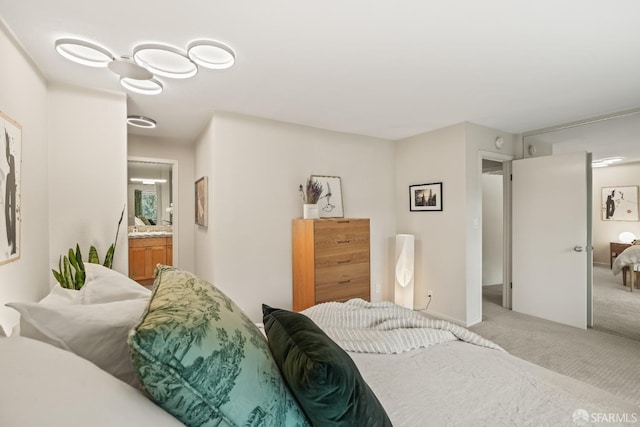 carpeted bedroom featuring ensuite bath