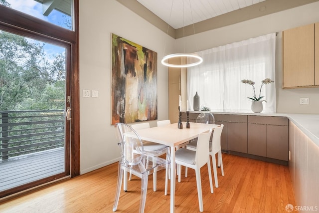 dining area featuring baseboards and light wood finished floors