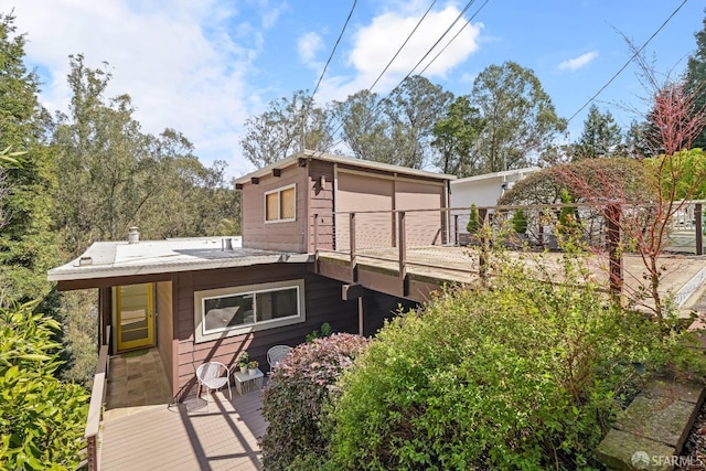 rear view of property with a wooden deck