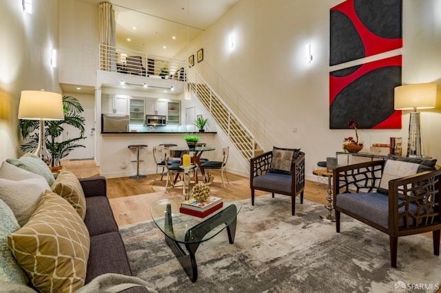3118 18th St Unit 2, San Francisco, CA 94110 - living room featuring a high ceiling, wood finished floors, and baseboards
