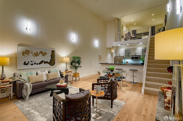 3118 18th St Unit 2, San Francisco, CA 94110 - living room with a high ceiling, wood finished floors, stairway, and baseboards