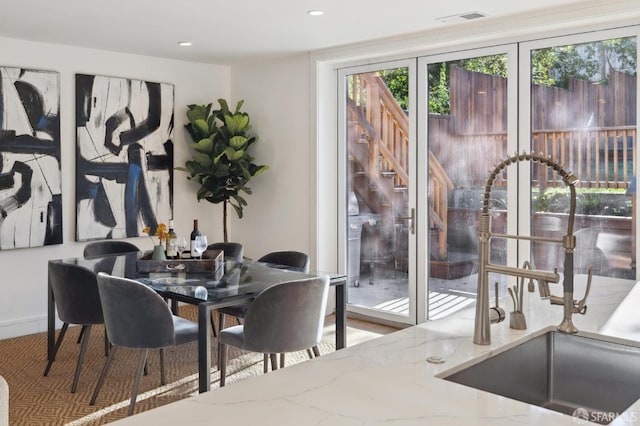 dining space with sink, french doors, and a wealth of natural light