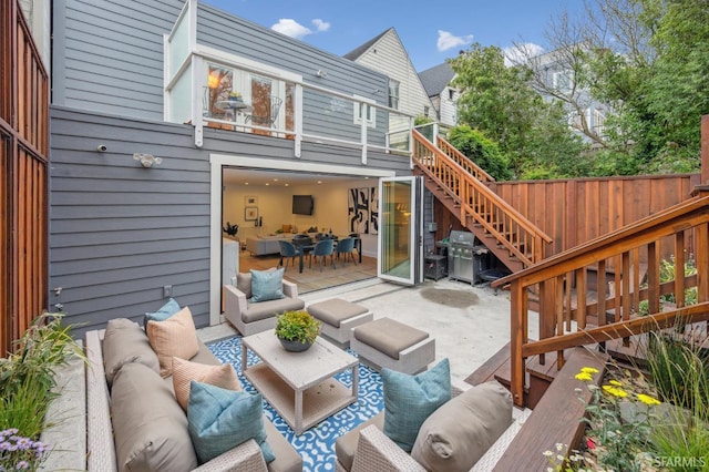 exterior space featuring a deck, outdoor lounge area, and a patio area