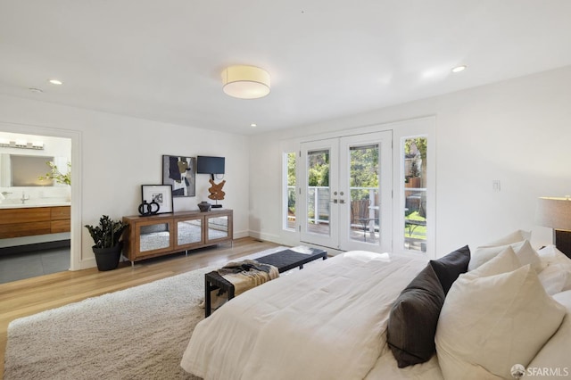 bedroom with access to outside, french doors, connected bathroom, and light hardwood / wood-style floors