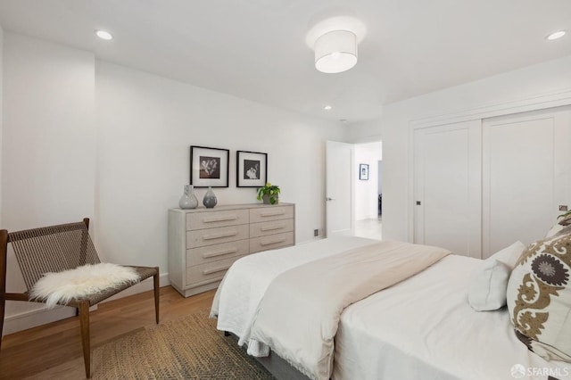 bedroom featuring a closet and dark hardwood / wood-style flooring