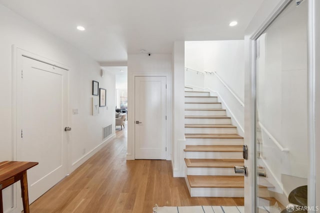 stairs with hardwood / wood-style flooring