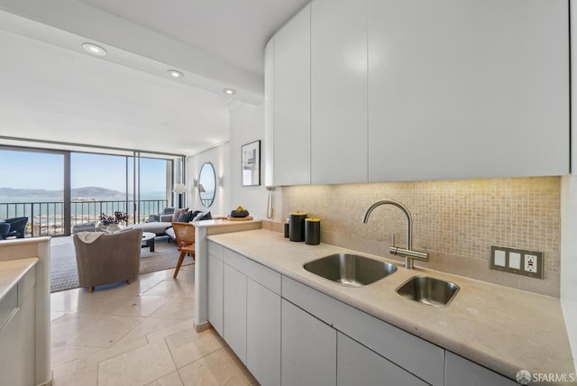 999 Green St Unit 1403, San Francisco, CA 94133 - kitchen with tasteful backsplash, light countertops, a water view, open floor plan, and white cabinetry