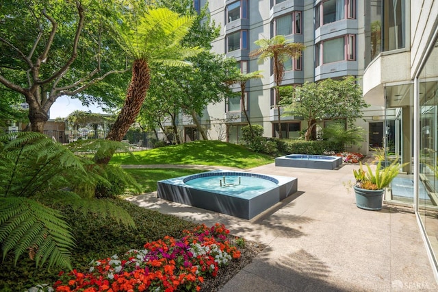 201 Harrison St Unit 302, San Francisco, CA 94105 - view of swimming pool featuring a hot tub, a patio, and a lawn