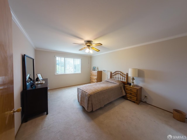 carpeted bedroom with ceiling fan and ornamental molding