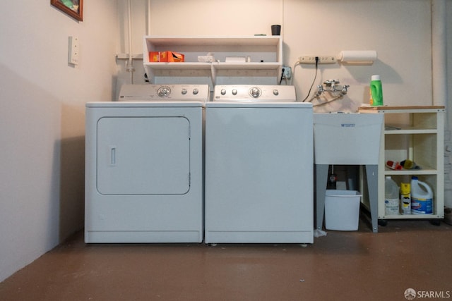 clothes washing area featuring laundry area and washer and clothes dryer