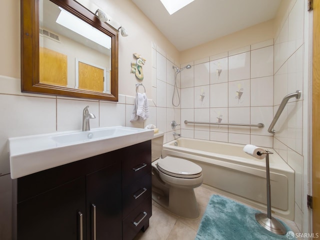 full bathroom with shower / bath combination, toilet, tile patterned flooring, vanity, and tile walls