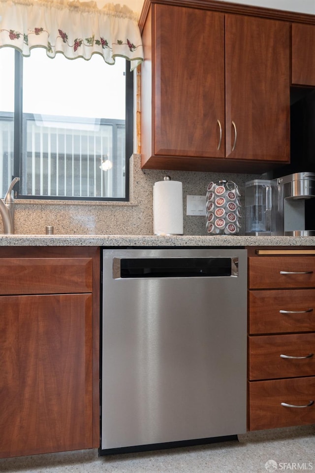 kitchen featuring dishwasher, light stone counters, brown cabinetry, and backsplash