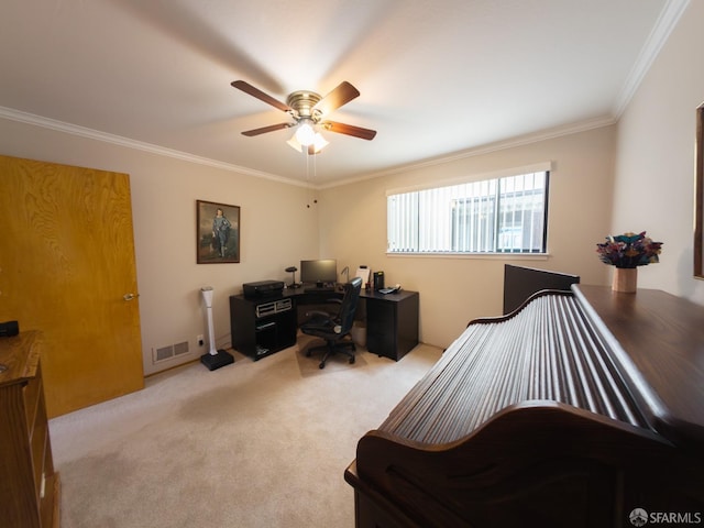 home office with ornamental molding, carpet flooring, visible vents, and a ceiling fan