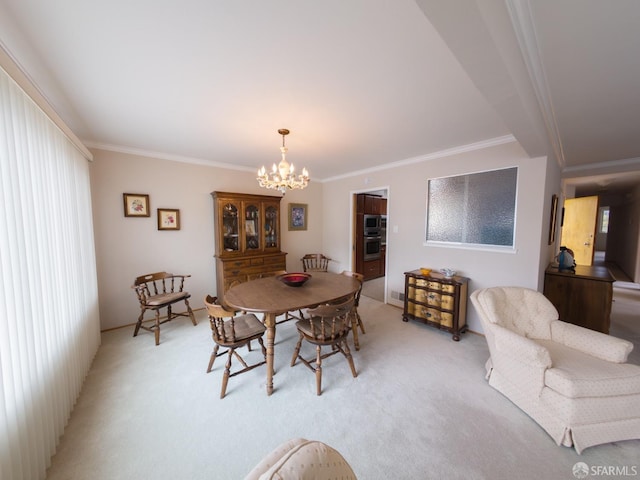 dining room featuring a chandelier, ornamental molding, and light carpet