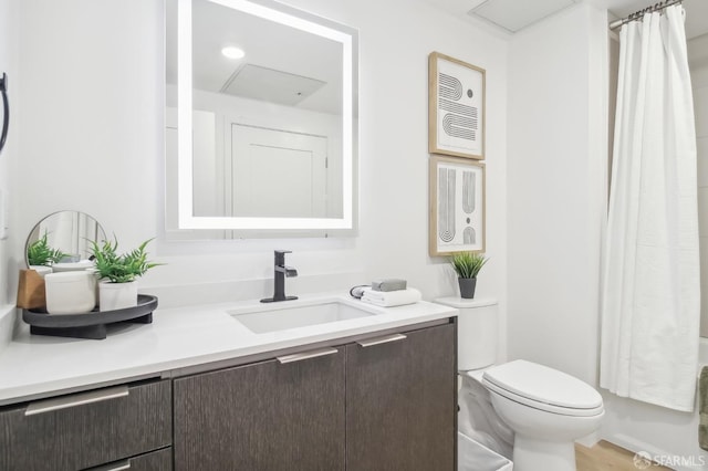 full bathroom featuring shower / bathtub combination with curtain, vanity, and toilet