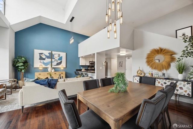 dining area featuring dark wood-type flooring and high vaulted ceiling