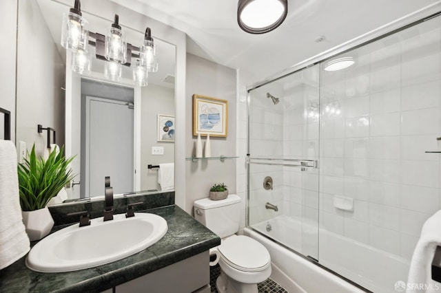 full bathroom with vanity, enclosed tub / shower combo, and toilet