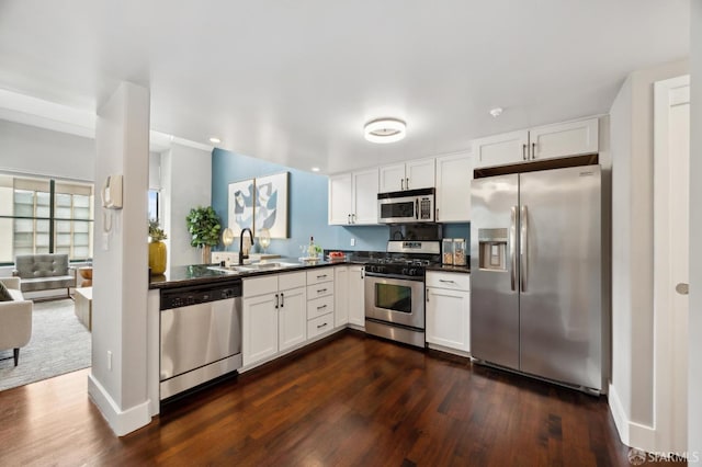 kitchen with white cabinetry, stainless steel appliances, and sink