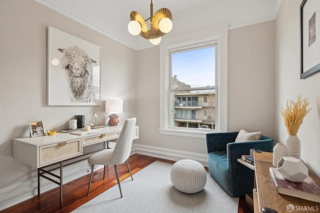 home office with crown molding, a notable chandelier, baseboards, and wood finished floors