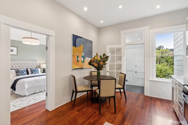 dining room with baseboards, dark wood-style flooring, and recessed lighting