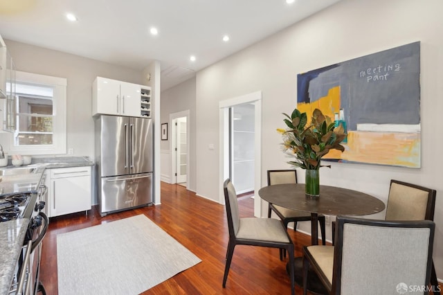 dining room with dark wood finished floors and recessed lighting