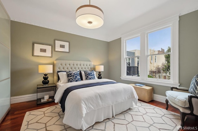 bedroom featuring baseboards and wood finished floors