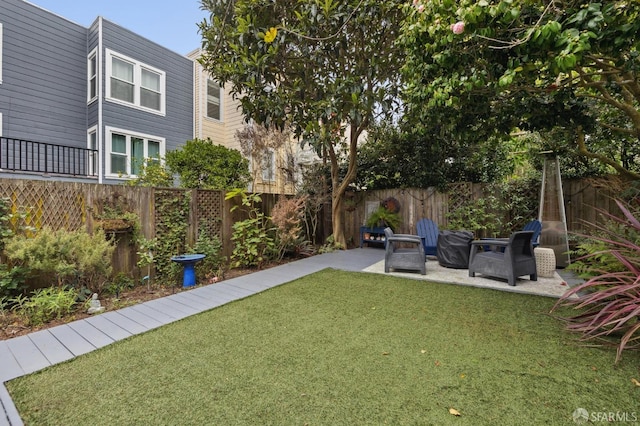 view of yard featuring an outdoor fire pit, a patio area, and a fenced backyard