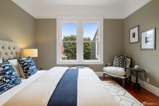 bedroom with baseboards and dark wood finished floors