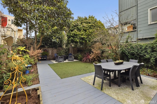 view of yard with fence, outdoor dining area, and a patio