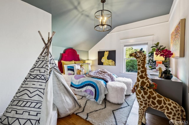 bedroom with lofted ceiling, hardwood / wood-style flooring, and a chandelier