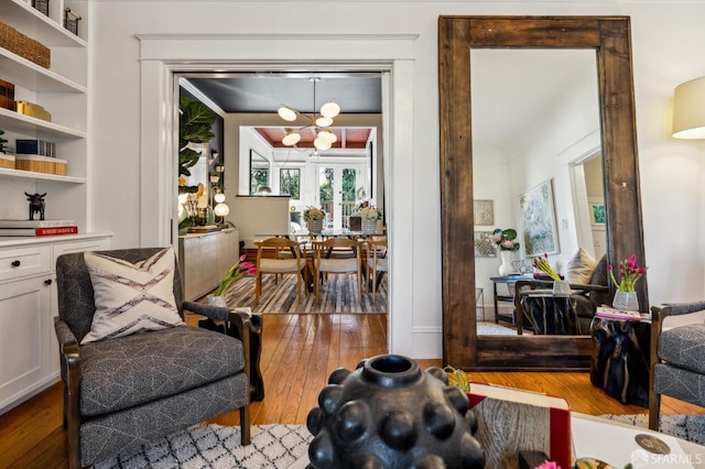 interior space featuring wood-type flooring and an inviting chandelier