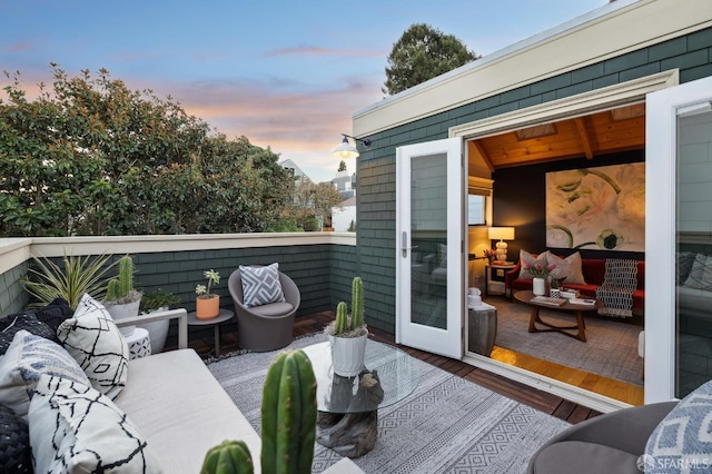 deck at dusk featuring an outdoor living space