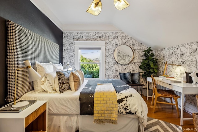 bedroom with hardwood / wood-style floors and vaulted ceiling