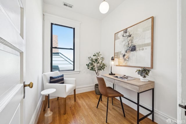 office featuring visible vents, light wood-style floors, and baseboards
