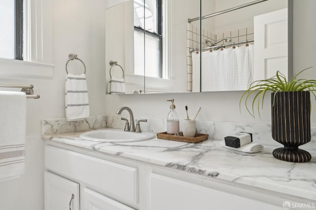 full bath with vanity and curtained shower