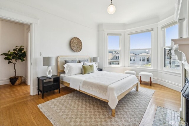 bedroom with baseboards and wood finished floors