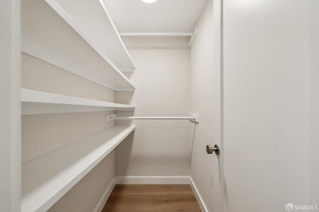835 Diamond St, San Francisco, CA 94114 - walk in closet featuring wood finished floors