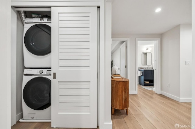 835 Diamond St, San Francisco, CA 94114 - laundry area with estacked washer and dryer, light wood finished floors, baseboards, and recessed lighting