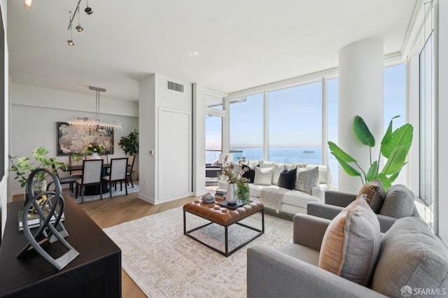 401 Harrison St Unit 45C, San Francisco, CA 94105 - living room featuring a chandelier, a water view, and light wood-style floors