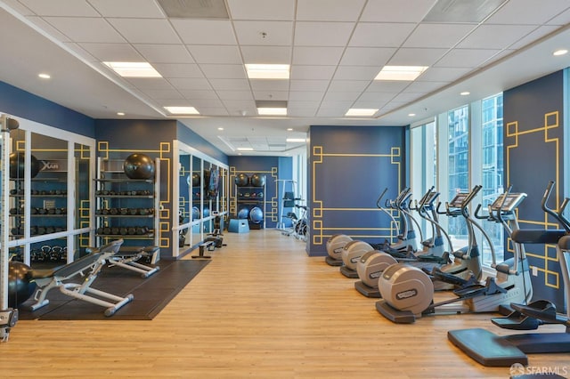 401 Harrison St Unit 45C, San Francisco, CA 94105 - exercise room featuring floor to ceiling windows, wood finished floors, and a drop ceiling