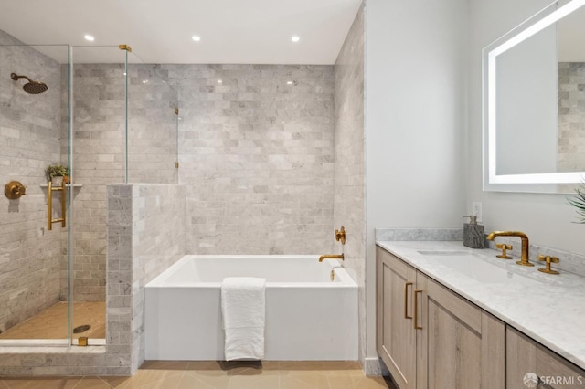 401 Harrison St Unit 45C, San Francisco, CA 94105 - full bathroom featuring a stall shower, vanity, a bath, recessed lighting, and tile patterned flooring