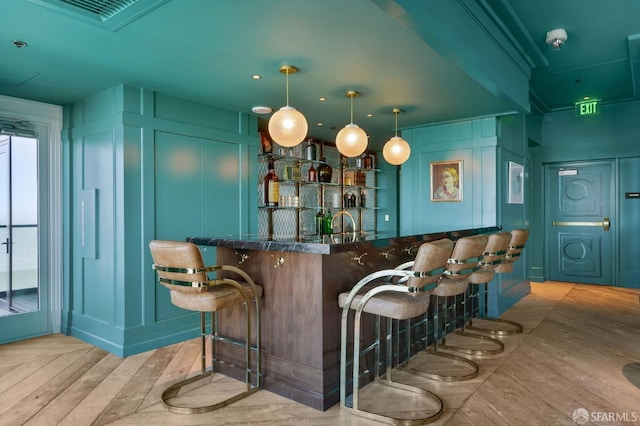 401 Harrison St Unit 45C, San Francisco, CA 94105 - indoor wet bar with a decorative wall, wood finished floors, and hanging light fixtures
