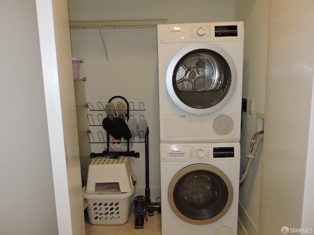 clothes washing area featuring stacked washer and dryer