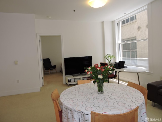 dining space with light colored carpet