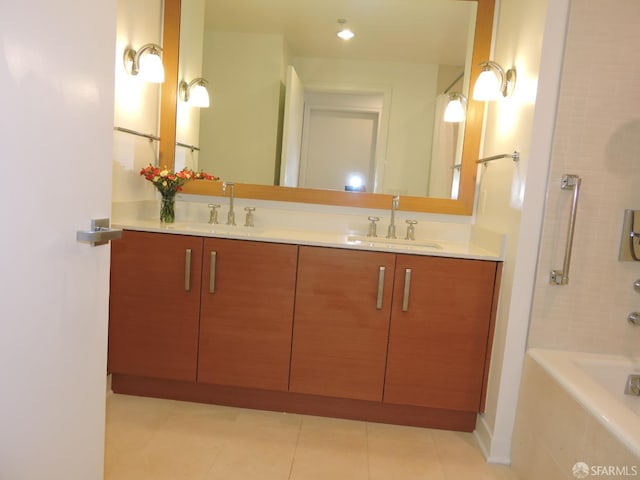 bathroom with tile patterned floors, tiled bath, and vanity