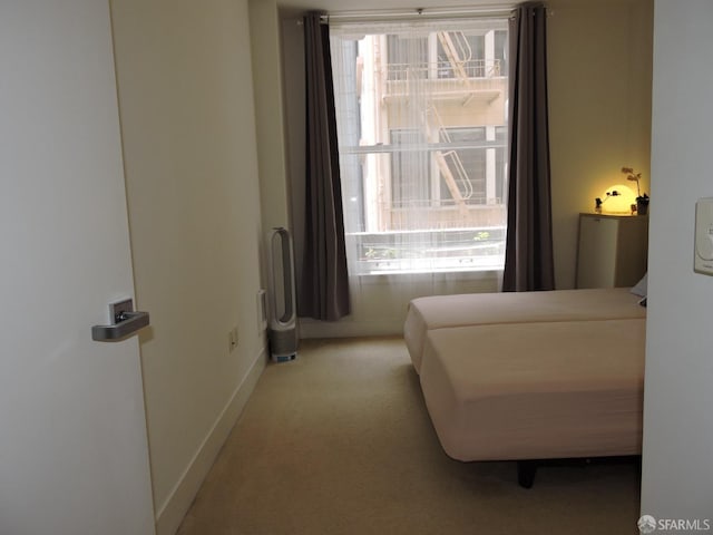 bedroom featuring light carpet